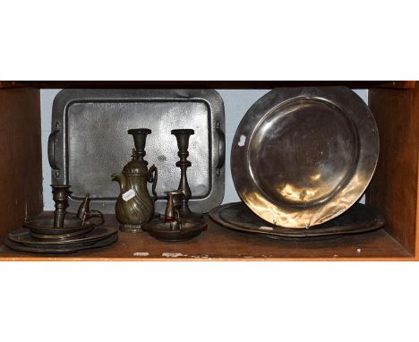 Pewter including Arts &amp; Crafts, twin-handled tray, 19th century charges, candlesticks etc (one shelf)