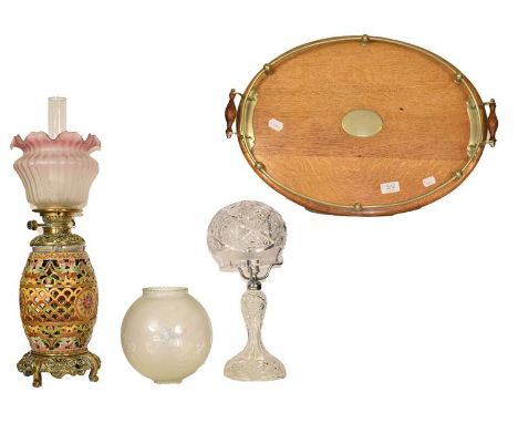 A reticulated pottery based oil lamp, probably Zsolnay, a cut glass table lamp, a large lamp with quilted glass shade and an 