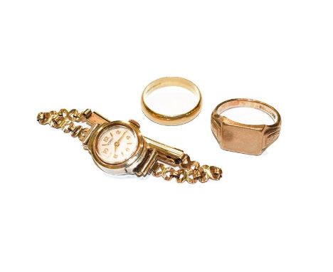 An 18 carat gold band ring, finger size T; a 9 carat gold signet ring, finger size U; and a lady's 9 carat gold wristwatch . 