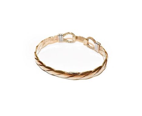 A 9 carat gold bangle, inner measurements 6.4cm by 5.2cm .  Gross weight 26.4 grams. 