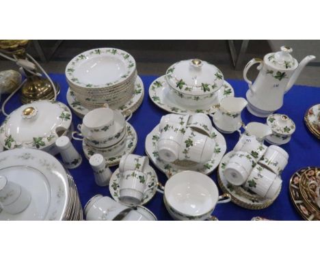 A Hammersley gilt rimmed and vine decorated dinner service comprising tea pot, tureens, serving plates, side plates, coffee c