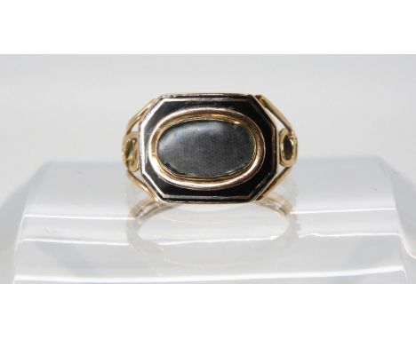 A yellow metal and enamel mourning ring with glazed panel, finger size O1/2, weight 3.2gms Condition Report:Available upon re