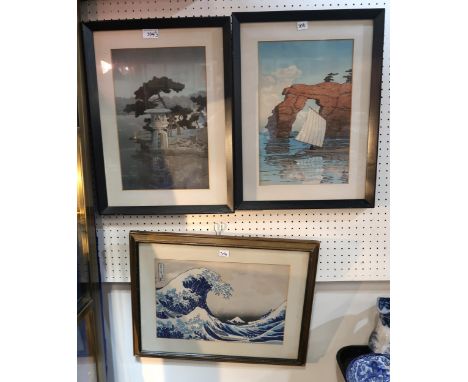 After Hokusai; a framed woodblock print of the Great Wave of Kanagawa, another of a boat and cliff outcropping, and another o