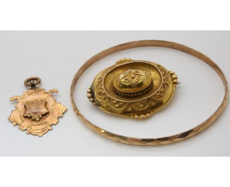 A 9ct medallion, yellow metal Victorian balloon brooch and a yellow metal bangle, weight combined 16.2gms Condition Report:Av