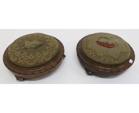 A pair of Victorian walnut circular footstools, one with tapestry upholstery depicting a dog and the other similarly upholste