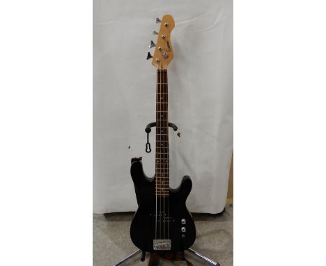 An encore short scale electric bass guitar in black with a large case Condition Report:Available upon request