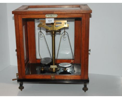 A balance scale by Thomson, Skinner &amp; Hamilton in glazed case, 37cm wide Condition Report:Available upon request