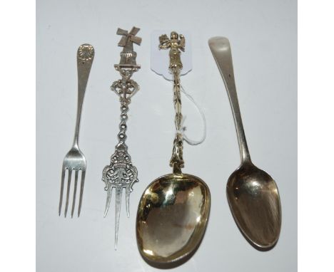 A Continental silver serving spoon with figural terminal, a similar fork with windmill terminal, a silver dessert spoon, Lond