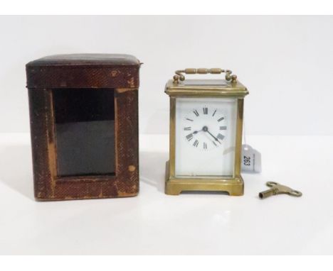 A 19th century French brass carriage clock with white enamel dial and roman numeral chapter ring, with original glass fronted