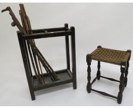 A 20th century oak stool with strung seat and a 20th century mahogany stick stand with assorted sticks Condition Report:Avail