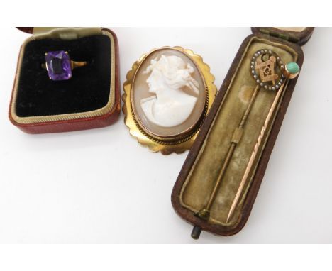 A 9ct gold amethyst ring size N1/2, a 9ct cameo brooch, a 9ct headed Masonic pin set with pearls, a yellow metal turquoise pi