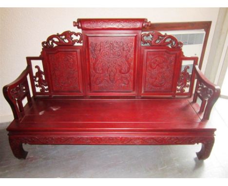 A CHINESE HARDWOOD CARVED BENCH SEAT with serpent armrests, 167cm wide