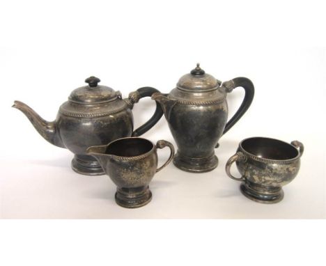 A FOUR PIECE SILVER TEA SERVICE W. Neale Ltd, Birmingham 1926, of plain form with cable border and leaf wrapped handle termin