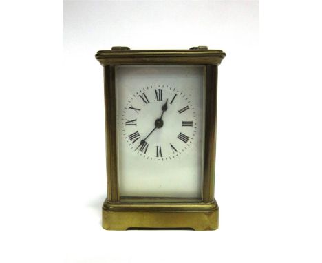 A VICTORIAN BRASS CASED CARRIAGE CLOCK the enamel dial with Roman numerals, and with carrying case