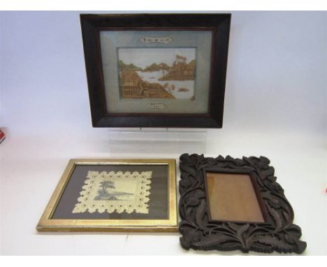 AN EARLY 20TH CENTURY CARVED WOODEN PHOTOGRAPH FRAME with a thistle border, the aperture 18cm x 13cm, overall 33.5cm x 28cm; 