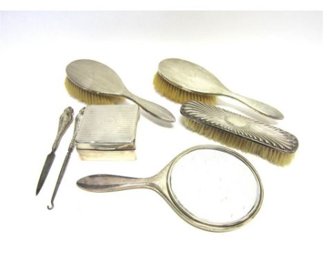 A THREE PIECE SILVER DRESSING TABLE SET a silver backed brush; a silver cigarette box, a button hook and a file