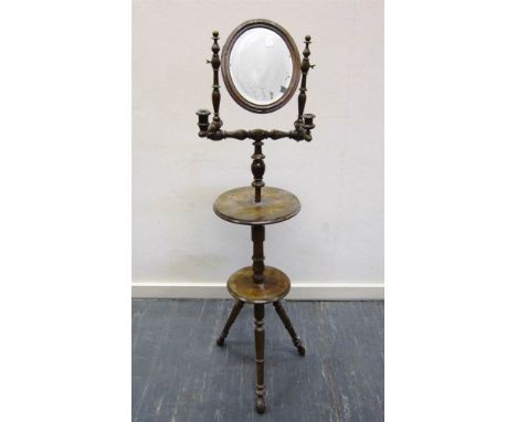 A VICTORIAN MAHOGANY SHAVING STAND the oval swing mirror flanked by a pair of candle brackets, the turned adjustable pedestal