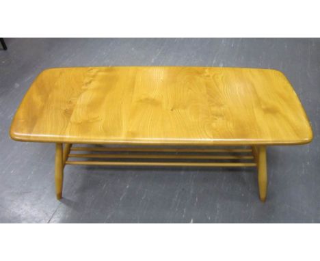 AN ERCOL LIGHT ELM RECTANGULAR COFFEE TABLE with magazine rack, 106cm long, 37cm high, 46cm deep