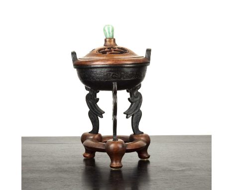 Shang style bronze vesselChinese, 19th Centuryset on stylised winged supports, with a pierced hardwood cover set with a jade 