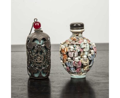 Two snuff bottlescomprising of moulded porcelain snuff bottle decorated with famille rose enamels depicting the 'Eighteen Loh