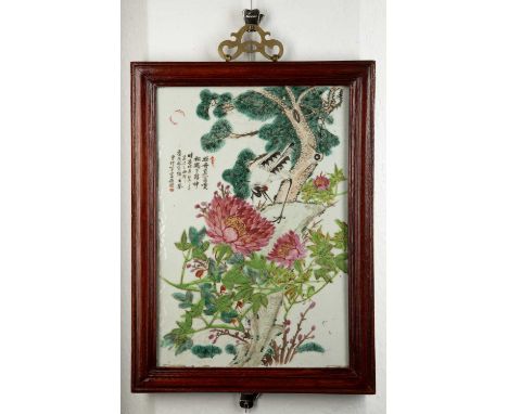 Porcelain panelChinese, 20th Centurywith inscription and red seal mark, and painted with peonies, bird and a pine tree, frame