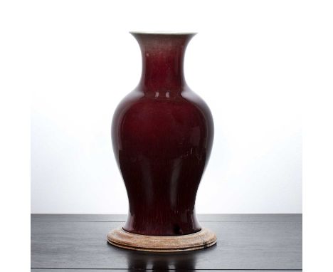 Sang de boeuf vaseChinese, 18th/ early 19th Centuryof baluster form, with a wooden stand, 35cm highProvenance: Hazelwood, Sha