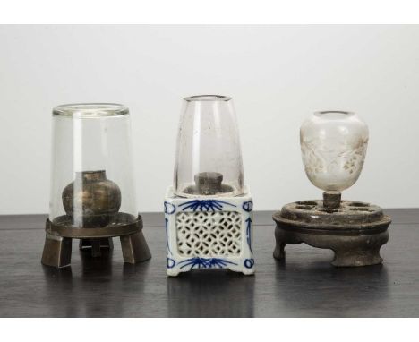 Three small oil lampsChineseto include a lamp with a porcelain base, and two metal lamps (3)The porcelain lamp has a chip and