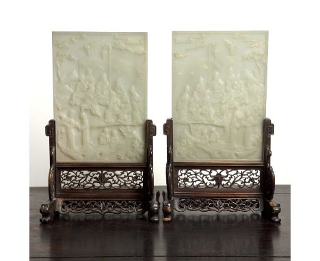 Pair of white jade table screensChinese, Republic periodeach carved in relief depicting scholars, watching a performance, wit