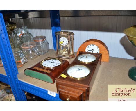 A clock barometer and three mantel clocks