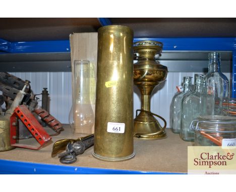 A brass shell case, fire irons and a brass oil lamp converted to electric&nbsp;