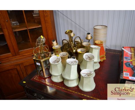 A brass six branch chandelier and a quantity of various shades, including a brass and glass hanging light fitting