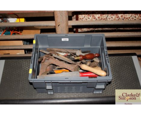 A box containing hand tools and a shoe last