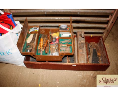 A wooden box and cantilever tool box with contents of various hand tools