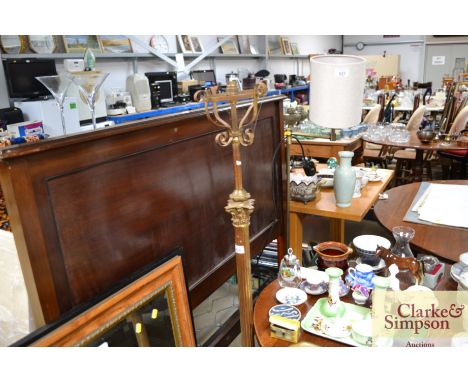A Corinthian column adjustable brass standard lamp raised on paw feet