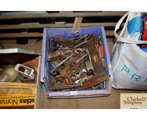 A box of various hand tools to include spanners; bench vice etc