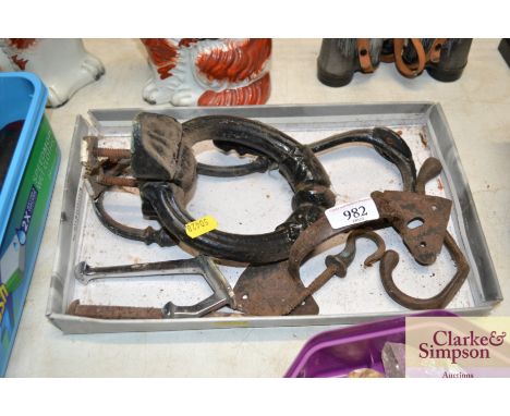 A heavy cast metal door knocker, hooks etc.