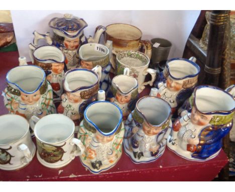 A large quantity of Staffordshire Toby jugs with painted and copper lustre decoration - sold with a similar double sided teap