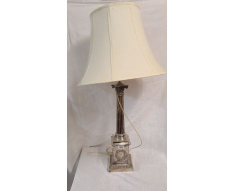 A 55.5cm high silver plated Corinthian column table lamp, set on a wreath decorated stepped plinth base bearing presentation 