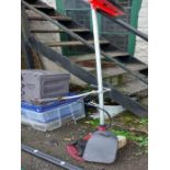 A petrol garden strimmer with harness