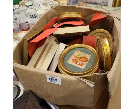 A box containing a collection of small oval framed machine tapestry floral studies and French small format portrait etchings