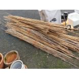 A quantity of long bamboo garden canes