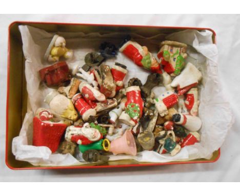 A tin containing a quantity of ceramic and plaster Christmas cake decorations including snow babies - sold with a small quant