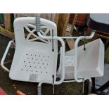 A white plastic bath chair