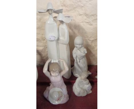A Lladro porcelain figurine depicting two nuns, a Nao figurine depicting an angel, a Nadal porcelain figurine and a Kaiser bi