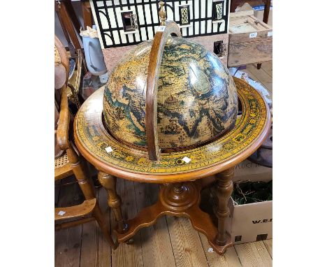 A large late 20th Century Italian globe of the world drinks cabinet, set on turned supports and shaped undertier with casters