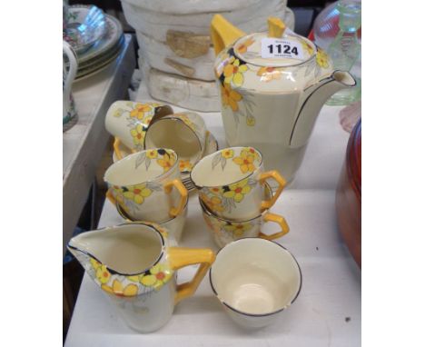 A Crown Ducal pottery Art Deco coffee set with a bold hand painted floral decoration on an ivory ground, comprising coffee po