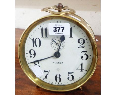 A vintage brass cased large alarm clock with Arabic numerals and name Rouser to dial - overwound