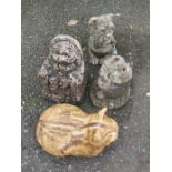 Four garden ornaments including a pottery cat