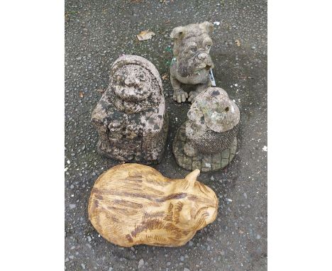 Four garden ornaments including a pottery cat