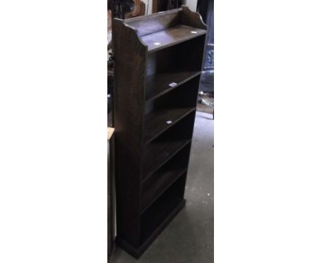 A 48cm vintage stained oak five shelf open bookcase, set on plinth base
